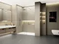 Salle de bain moderne avec un grand miroir lumineux, un lavabo suspendu et une douche à l'italienne. Le ressaut douche est discret, intégré au design épuré.