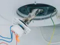 Élément chauffant d'un chauffe-eau couvert de tartre, nécessitant un détartrage. Les fils électriques sont visibles.