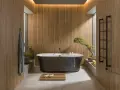 Une **salle de bain japandi** apaisante avec baignoire îlot, murs en bois, et un bonsaï.