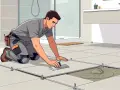 Un carreleur pose du carrelage dans une salle de bain, assurant une pose parfaite pour la décennale carrelage.