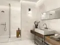 Salle de bain moderne avec carrelage 60x120 pose décalée, douche vitrée, vasque en pierre et meuble en bois.