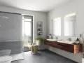 Salle de bain moderne avec douche, double vasque et carrelage gris. Le gris est la couleur la moins salissante pour une salle de bain.