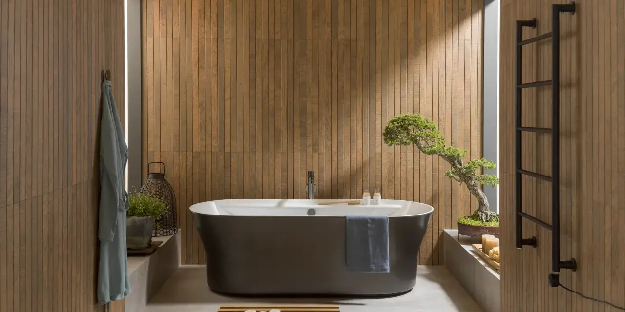 Une **salle de bain japandi** apaisante avec baignoire îlot, murs en bois, et un bonsaï.