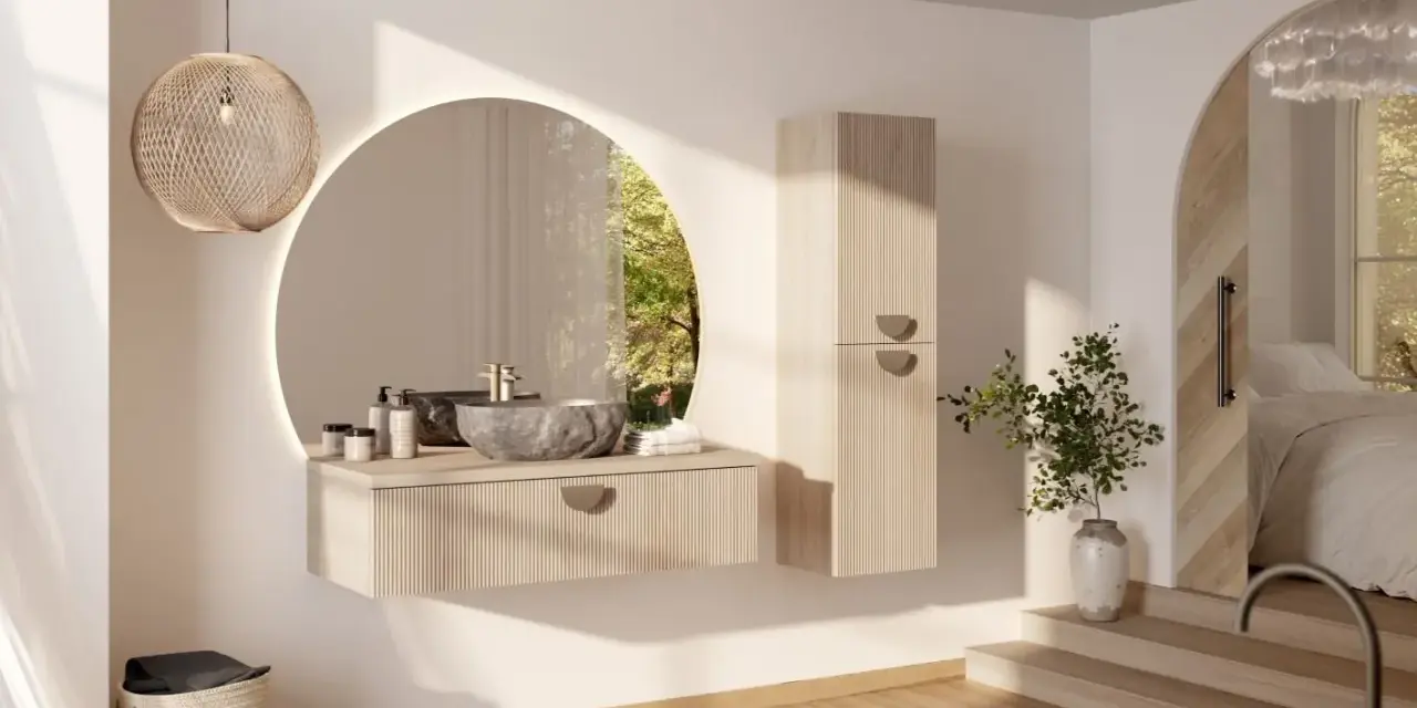 Une salle de bain épurée avec une vasque en pierre, un miroir rond et une touche de verdure. Une **déco salle de bain nature** apaisante.