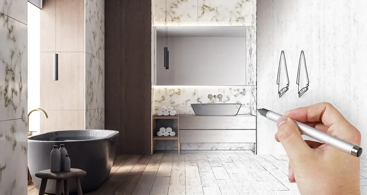 Main d'un architecte esquissant le schema d'evacuation baignoire dans une salle de bain moderne.
