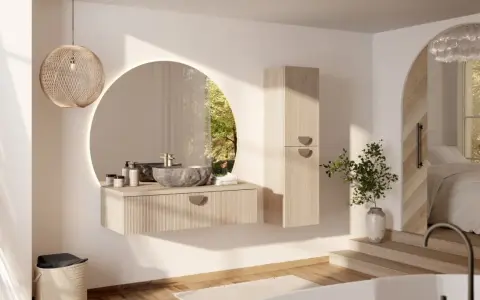 Une salle de bain épurée avec une vasque en pierre, un miroir rond et une touche de verdure. Une **déco salle de bain nature** apaisante.