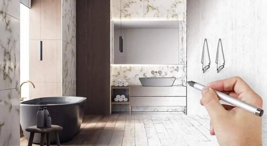 Main d'un architecte esquissant le schema d'evacuation baignoire dans une salle de bain moderne.
