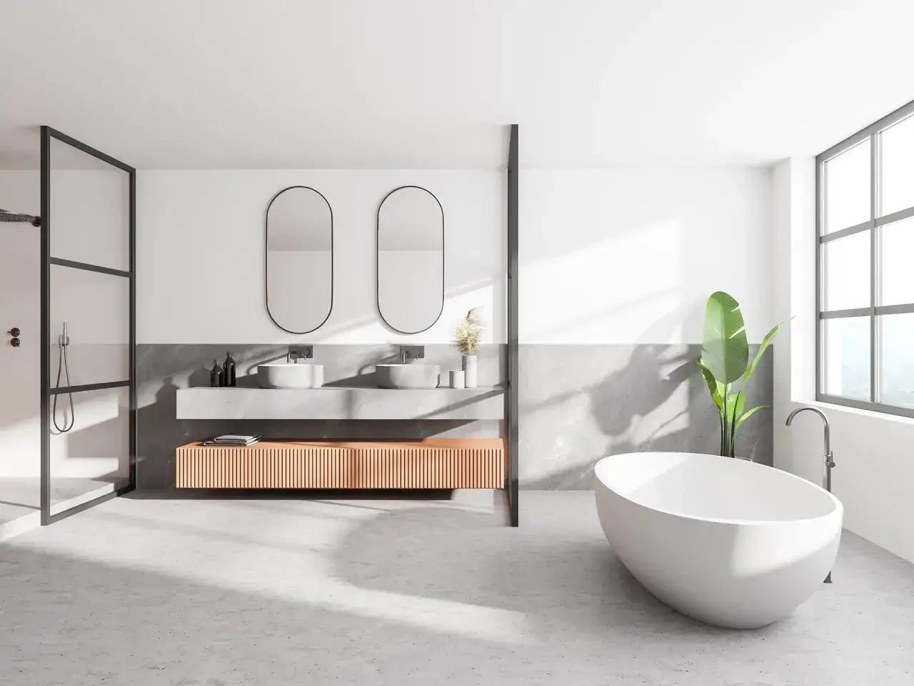Salle de bain moderne avec baignoire îlot, double vasque et douche à l'italienne. Le sol en béton ciré, un carrelage sans joint, crée une ambiance épurée et contemporaine.