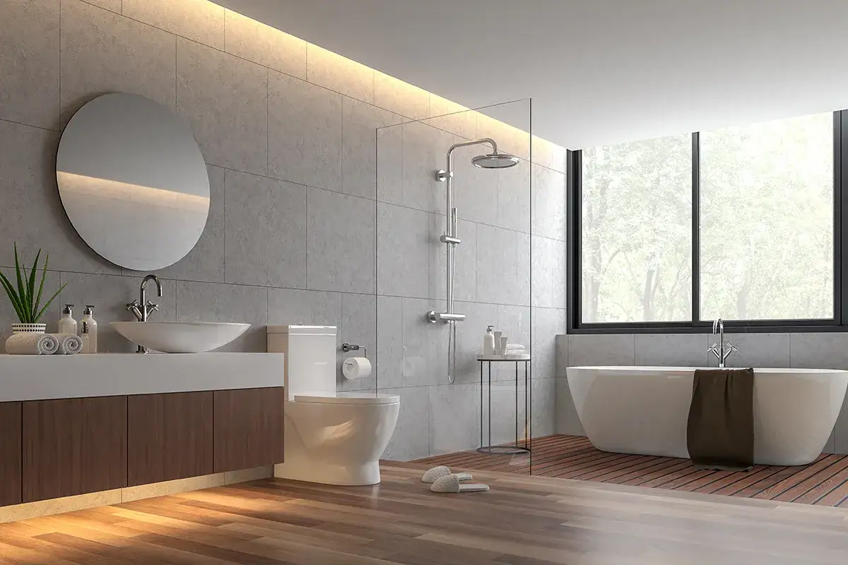 Salle de bain moderne avec baignoire îlot, douche, lavabo et toilettes. La jonction parquet carrelage crée un contraste chaleureux.
