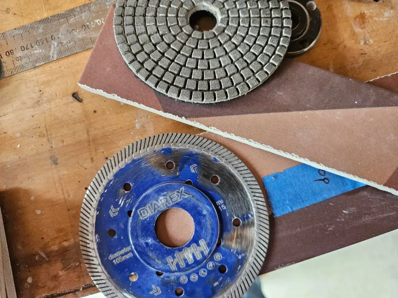 Disque de coupe pour couper carrelage, avec une meule diamantée et une règle graduée.